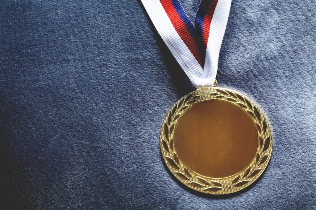 Gold medal on velvet cushion. Olympic games