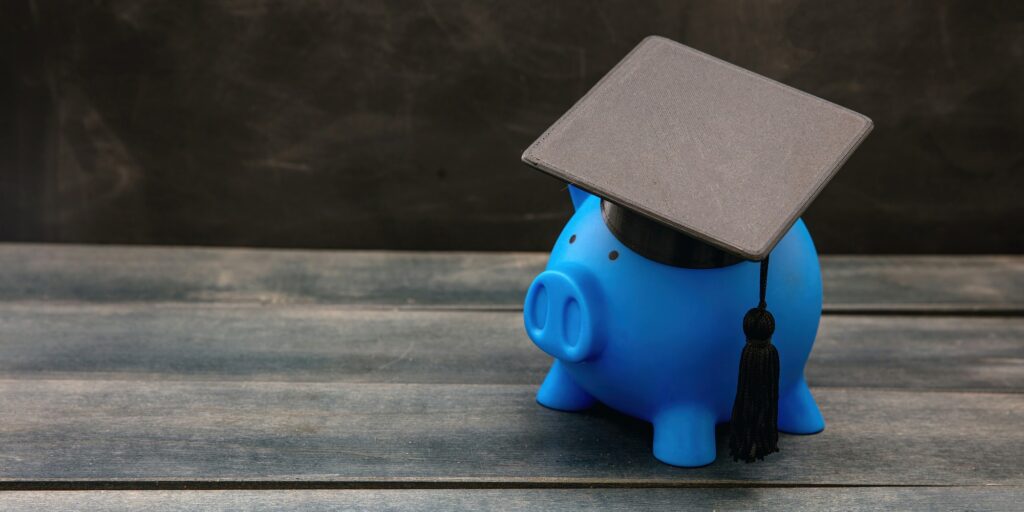 Education school cost, scholarship, student loan. Piggy bank with graduation cap