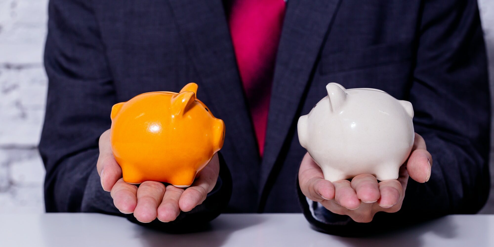 Businessman making a comparison and difference between each money piggy bank