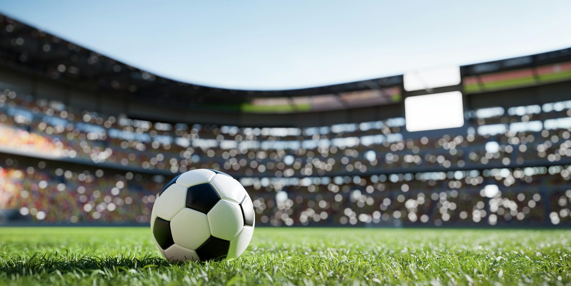 Football soccer ball on grass field on stadium