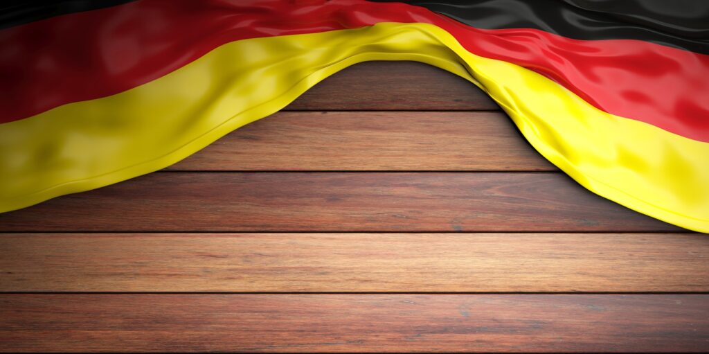 Germany flag placed on wooden background with copyspace. 3d illustration