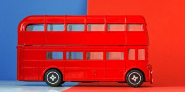 red double-decker tourist bus - symbol of Britain. minimalist travel background. british flag colors