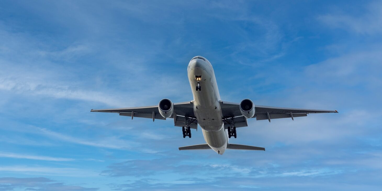 Airplane and sky, the plane is landing. Airplane take off on the blue sky