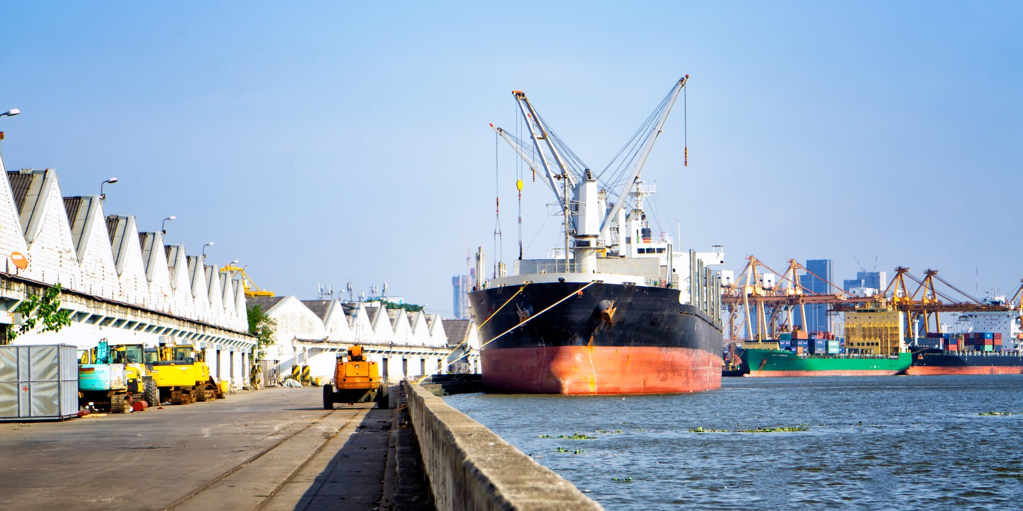 Container Ship Moored At Harbor Against Clear Sky