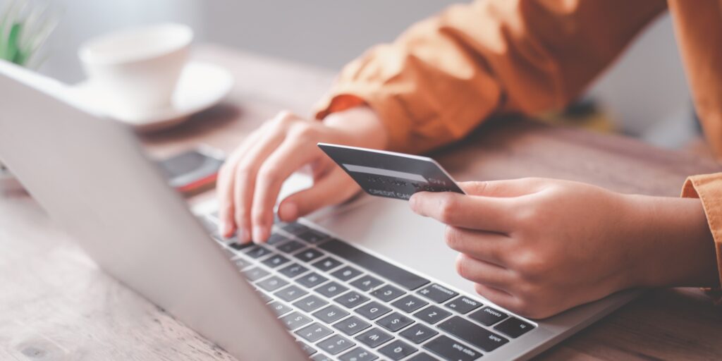 Women's hands holding a credit card and work on laptop Online payment for online shopping