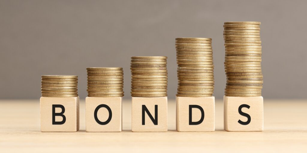 Bonds word in wooden blocks with coins stacked