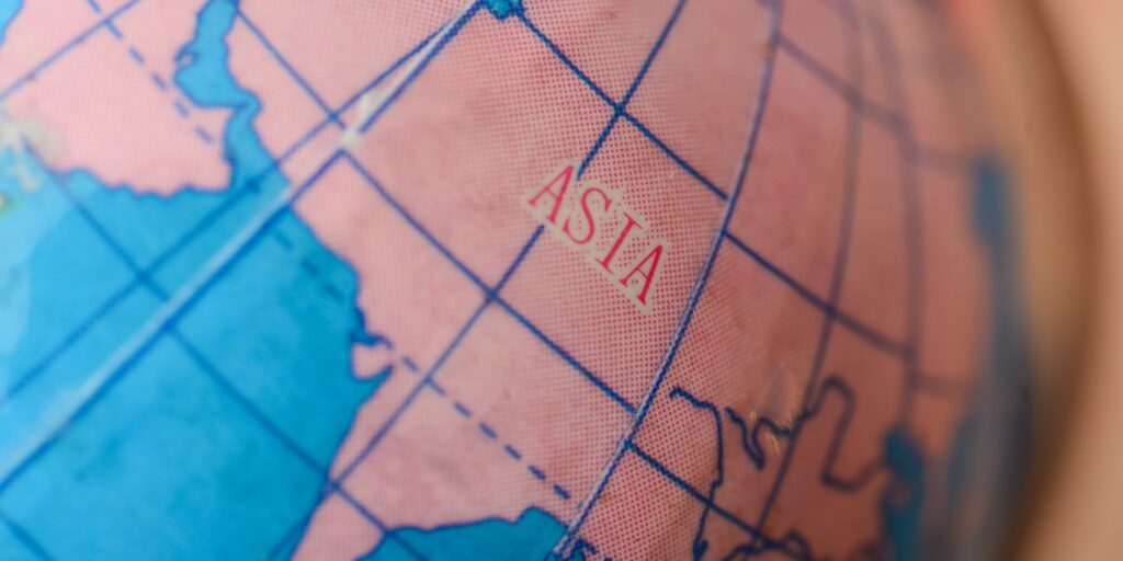 the Asia map on a globe beckons travelers to chart their journeys