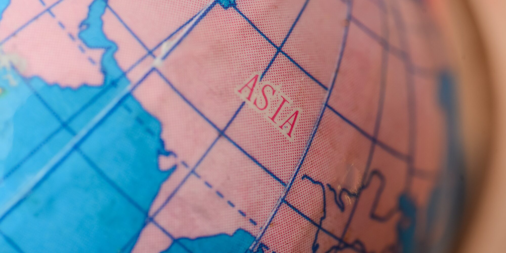 the Asia map on a globe beckons travelers to chart their journeys