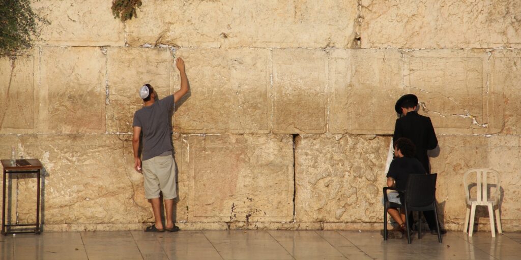 Jewish people praying to the Jerusalem's western wall, the wailing wall
