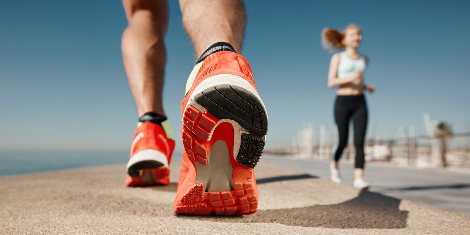 Runner feet running on road closeup on shoe. Sportsman fitness s